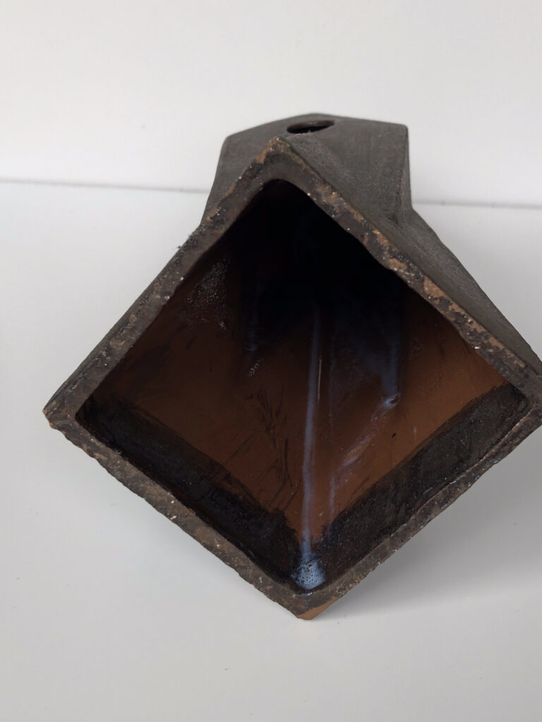 Bottom side HERLIV Brutalist ceramic monolith sculpture in the style of Jan van der Vaart, 30cm geometric stoneware totem with manganese oxide finish.